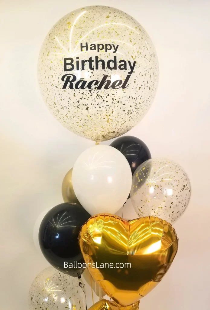 Happy Birthday personalized confetti balloons with white and black latex balloons, along with a gold heart-shaped balloon arranged in a bouquet to celebrate a birthday
