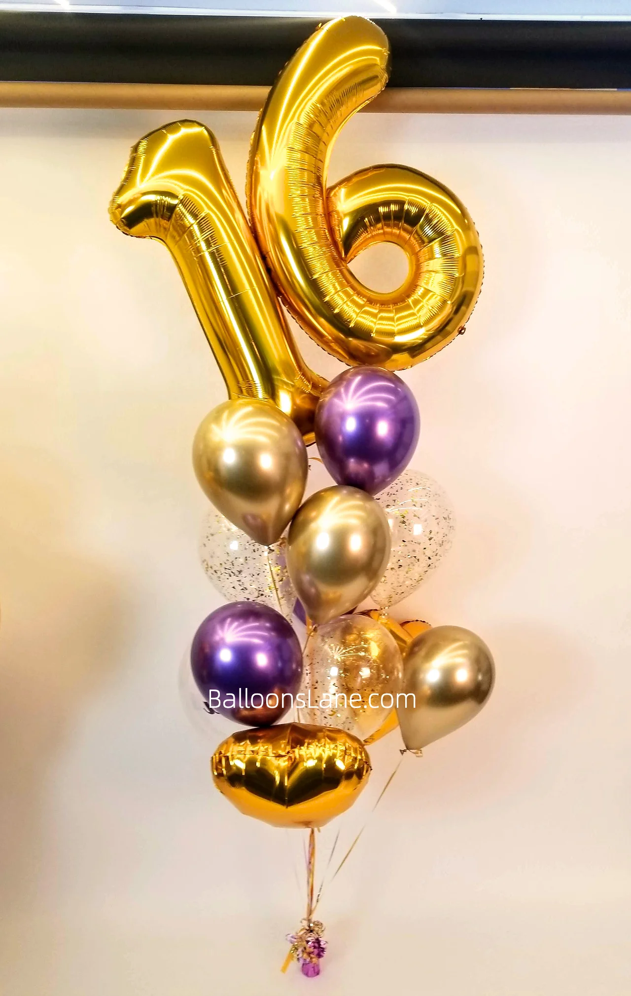 Large Number balloons 1 & 6 atop a bouquet arrangement featuring gold and purple latex balloons, a gold foil balloon, and gold confetti balloons to celebrate a birthday and anniversary in Manhattan.
