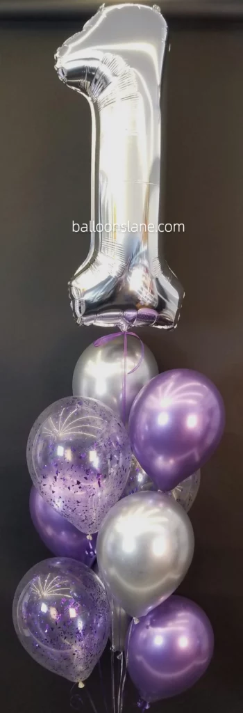 Large silver "1" number balloon accompanied by purple latex balloons, silver chrome balloons, and confetti in NJ.