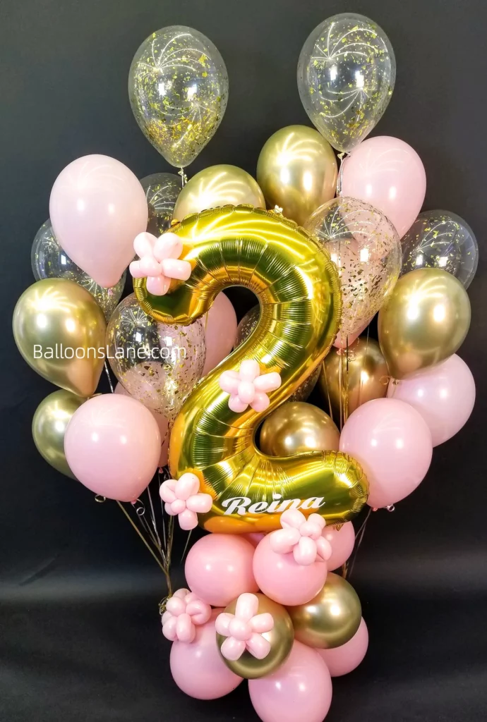 White and pink chrome gold confetti balloons with a number 2 and pink hanging decorations for a baby's 2nd birthday party.