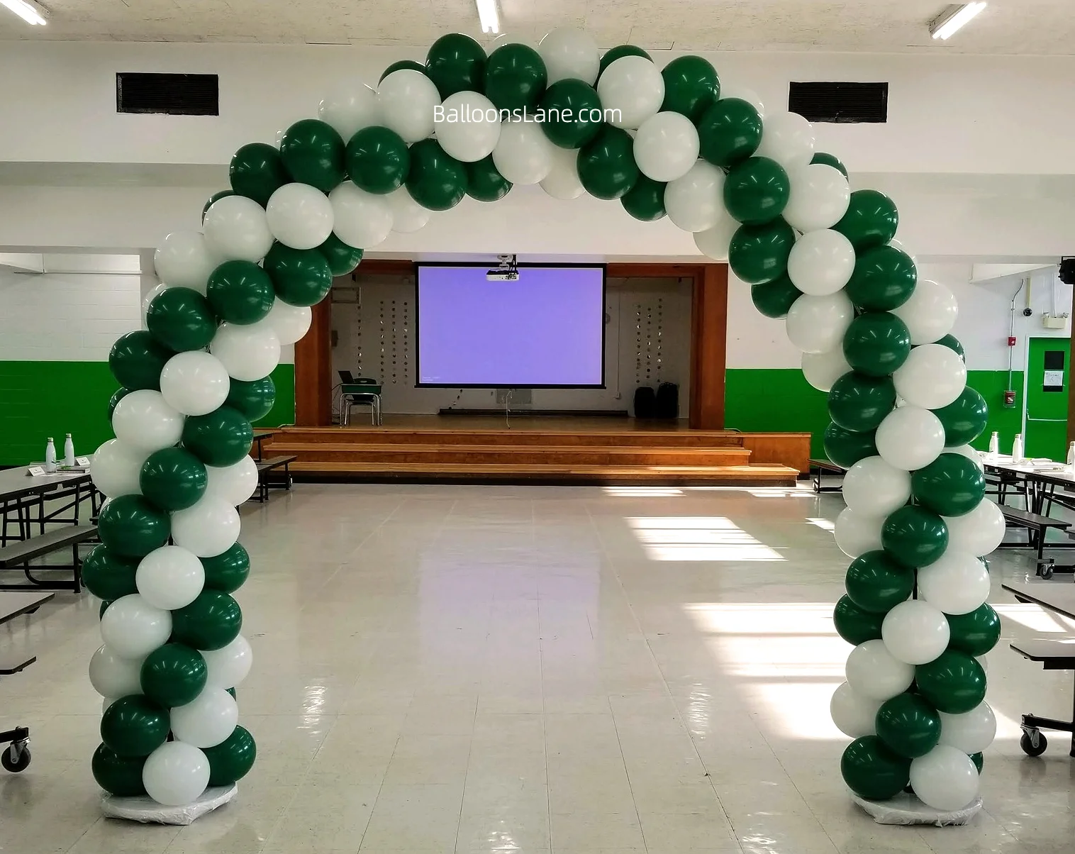 Arch made of green and white latex balloons.