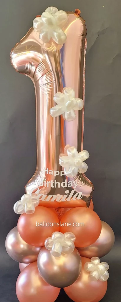 Large rose gold number balloon accompanied by peach and rose gold latex balloons, as well as chrome balloons in NJ.