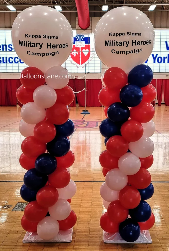 Column made of red, blue, and white balloons with a customized white balloon on top.