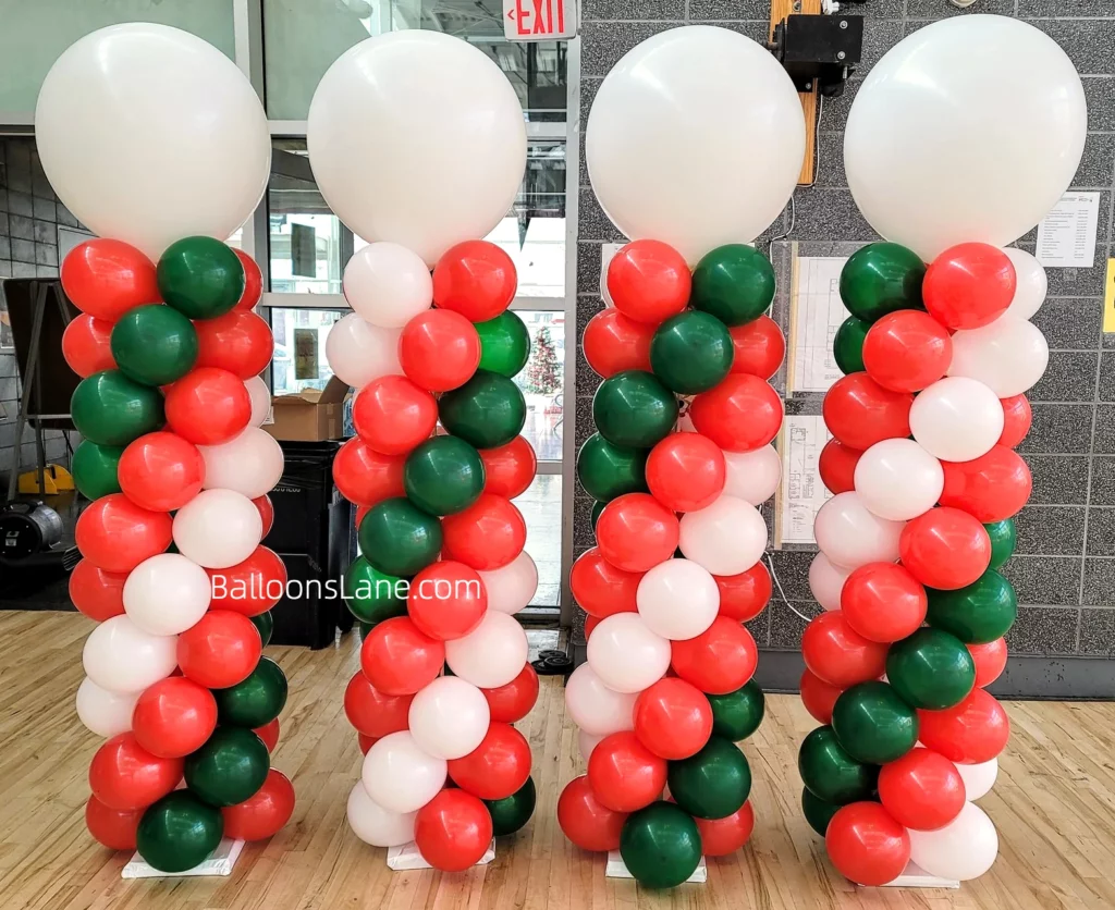 Colorful balloon decorations featuring red, white, and green balloons, accompanied by white and chrome balloon columns.