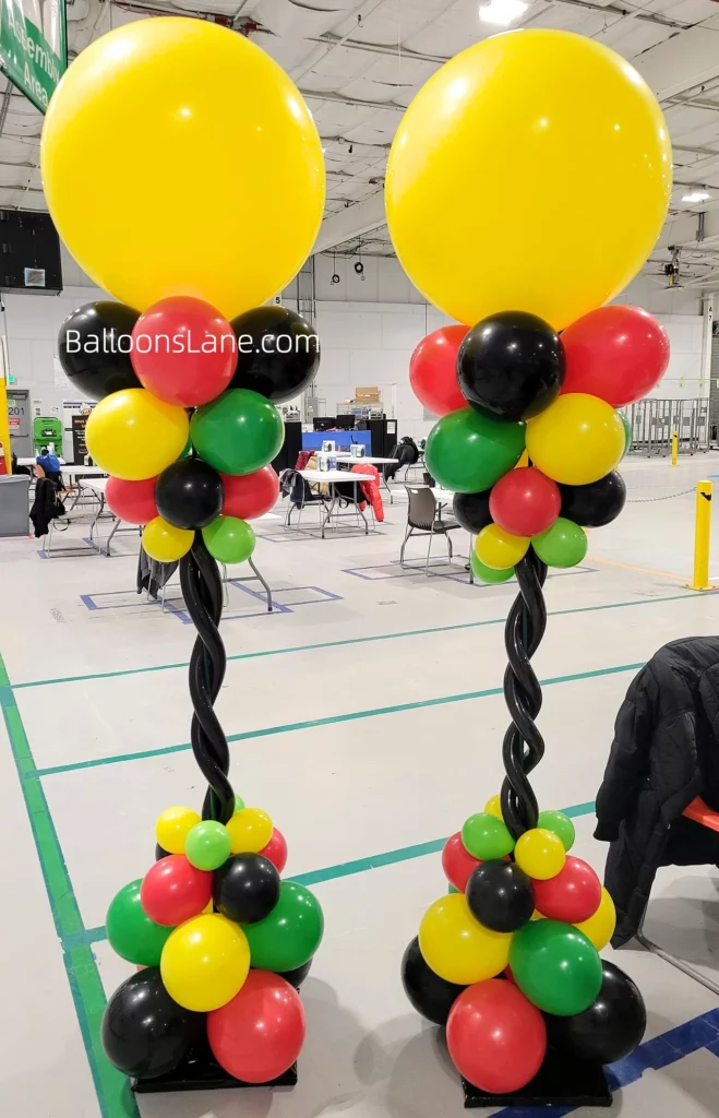Large Yellow Balloon Bouquet with Small Red, Yellow, Green, and Black Balloons, Adorned with Black Twisted Balloons in Brooklyn