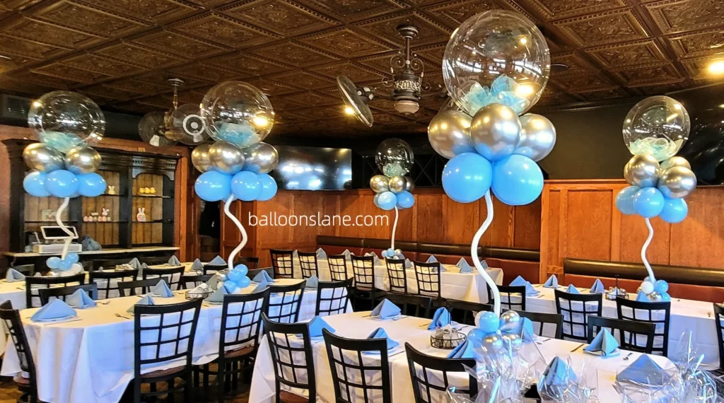 Blue and silver christening balloon centerpieces, along with clear large balloon centerpieces, to make your little one feel special in NYC.