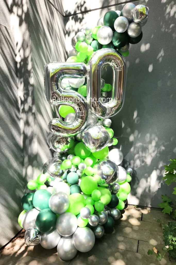 Beautiful balloon garland with large 50 number balloons, mint green, dark green, and silver grey balloons in Brooklyn