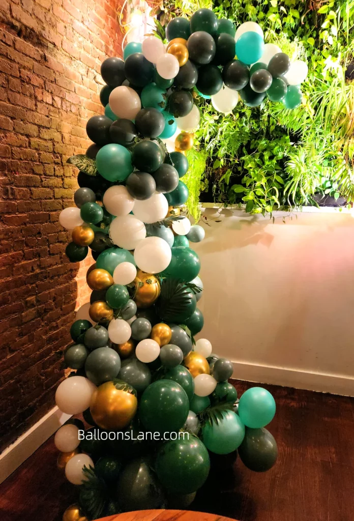 Green, grey, black, gold, and white balloons garland for celebrating engagement in Manhattan.