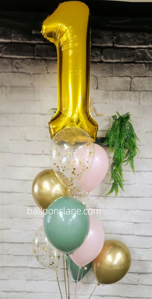 Number 1 balloon, confetti balloon, pink, and pastel green balloons arranged in Brooklyn to celebrate birthday