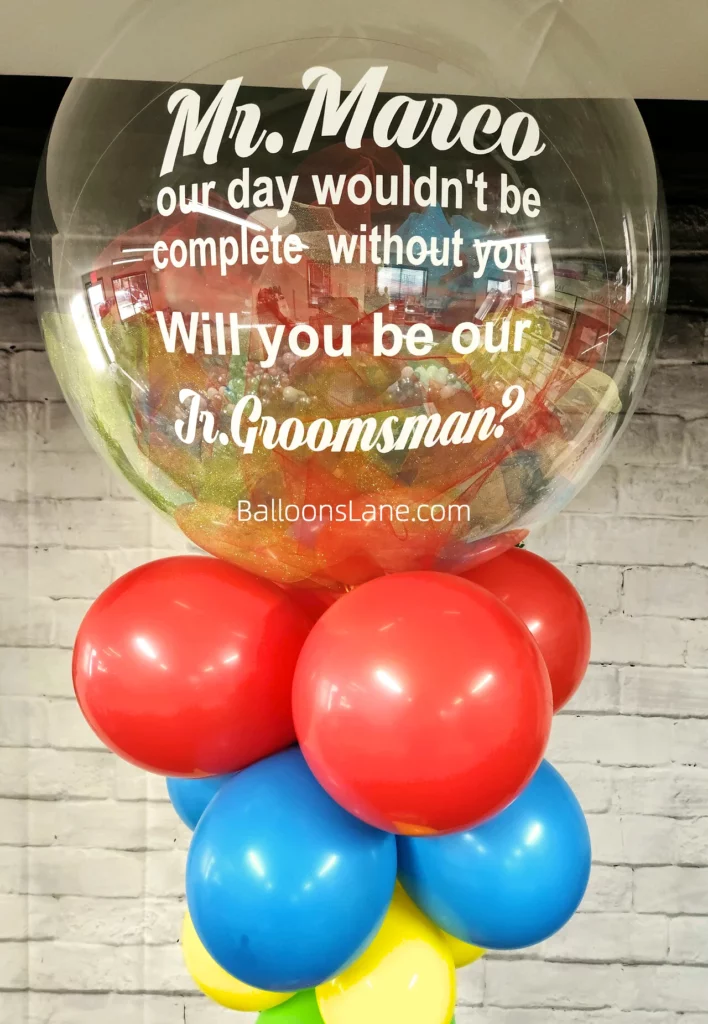 Customized clear balloon bouquet with red, blue, and yellow balloons