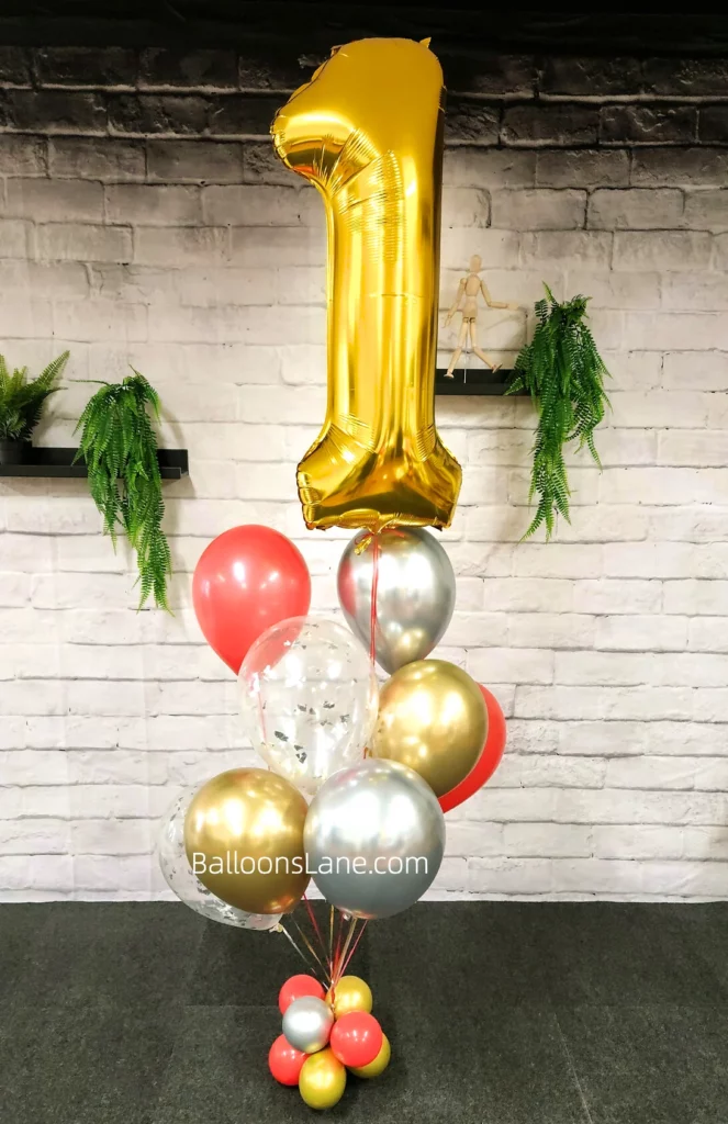Large number 1 balloon with red, gold, and silver balloons arranged in a bouquet to celebrate 1st birthday in NYC