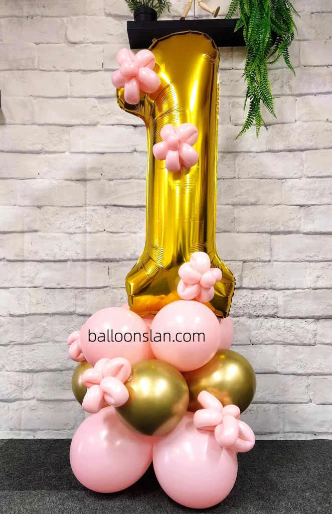 Pink, gold, and chrome gold colors featuring gold number balloon "1", balloon stand created by Balloons Lane in NYC for a 2nd birthday celebration.