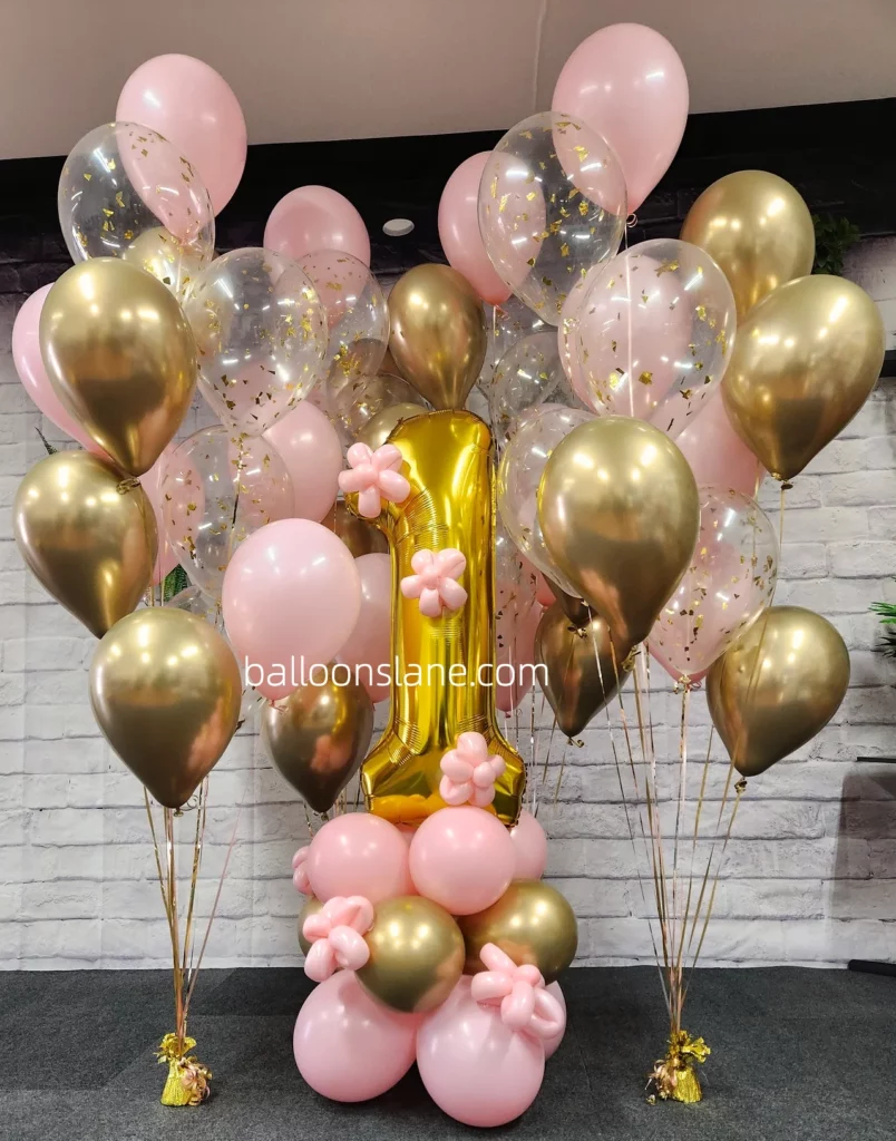 A beautiful balloon bouquet in pink, gold, and chrome silver colors, featuring gold number balloons created by Balloons Lane in New Jersey for a birthday celebration.