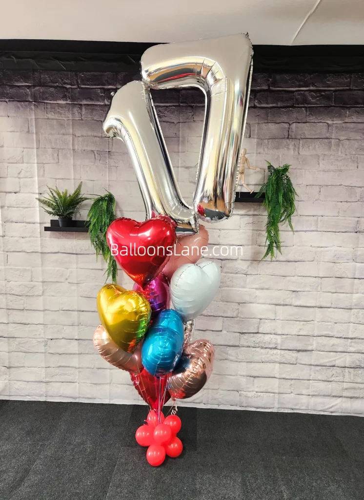 17 Foil number balloon in silver with red, gold, silver, pink, and blue heart shape balloons to celebrate 17th birthday in Manhattan