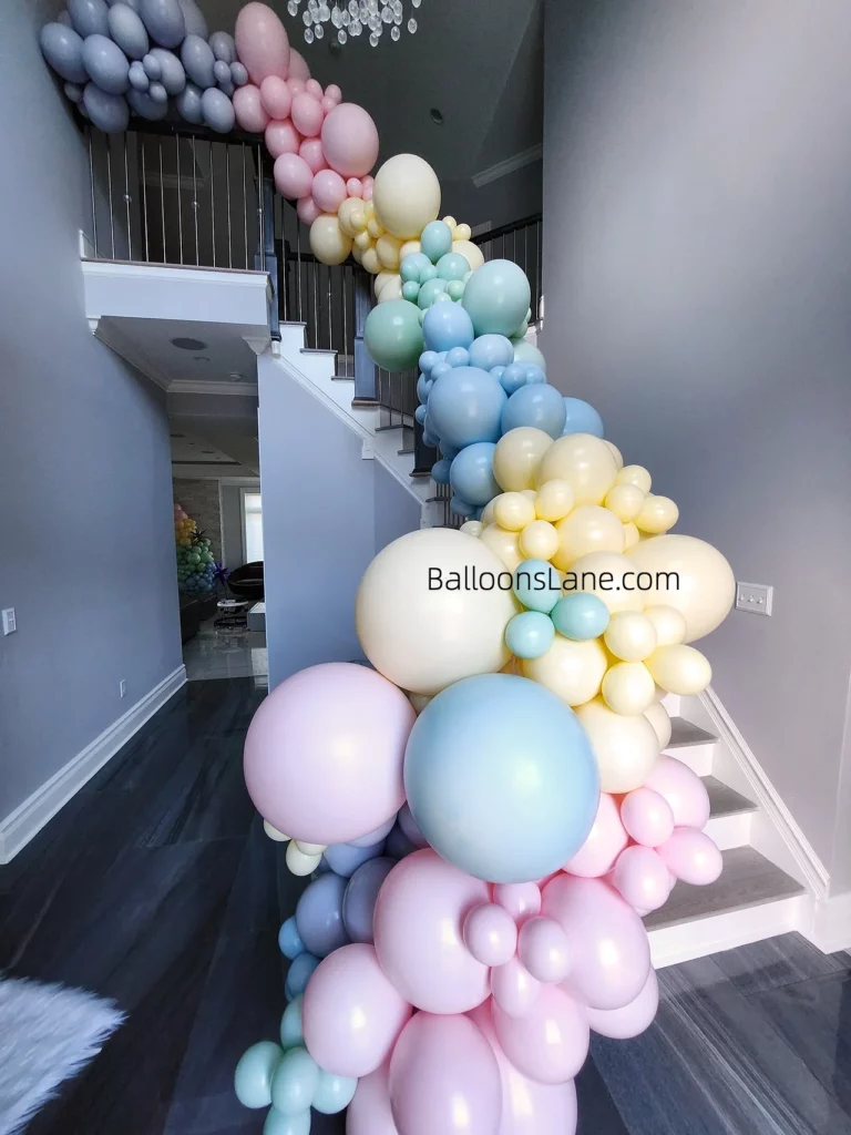 Pastel balloon garland adorned on staircase to elevate your birthday event in New York City.