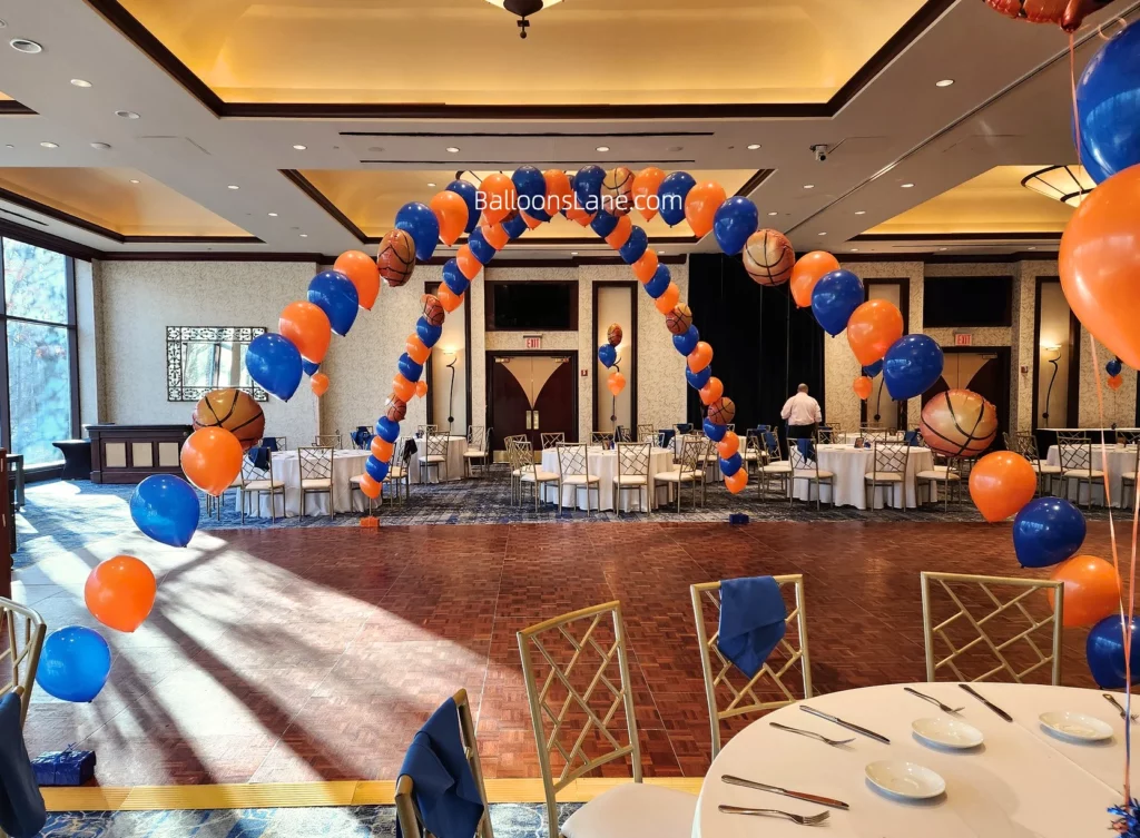 Arch made of orange and blue balloons with a football theme.