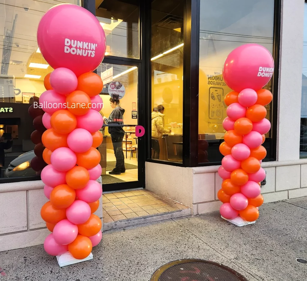 Dunkin' Donuts themed balloon column in NYC featured pink and orange balloons for corporate events.