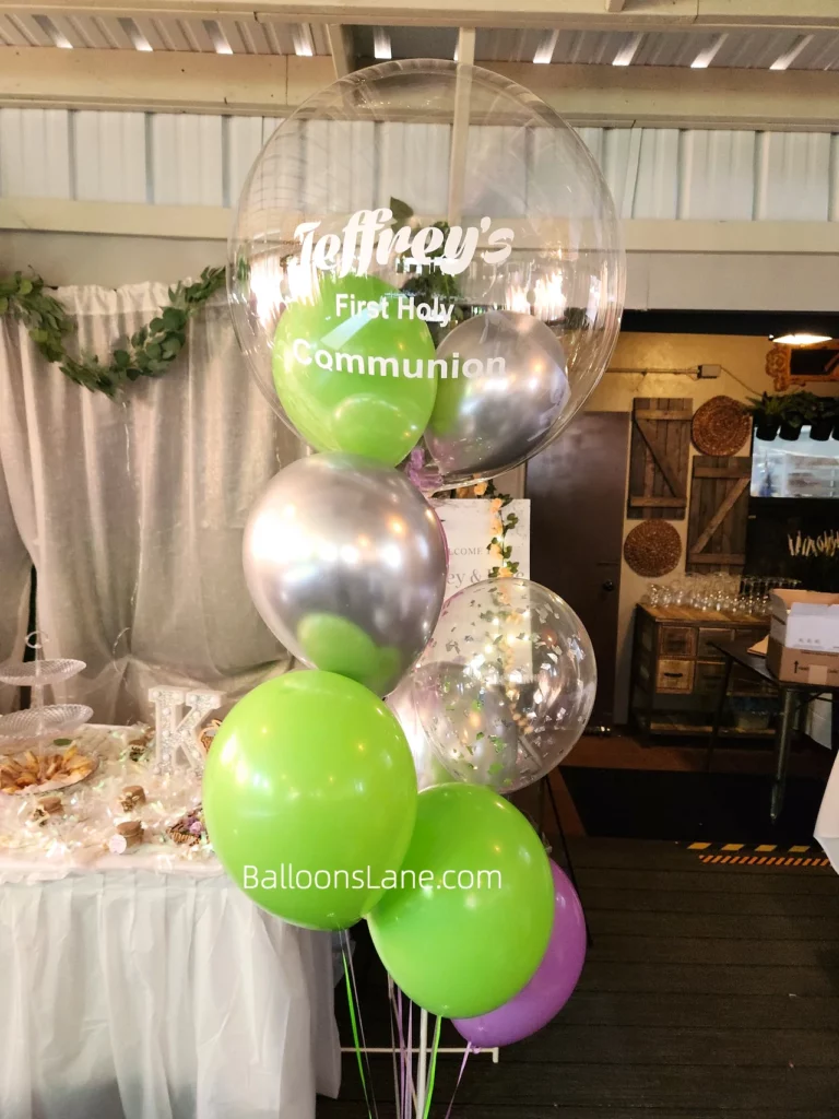 Customized balloon bouquet for First Holy Communion celebration, featuring green, pink, and chrome silver balloons in Staten Island.