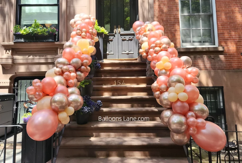 Peach, Pink, Yellow, and Rose Gold Balloon Garland Decorating a NJ Staircase