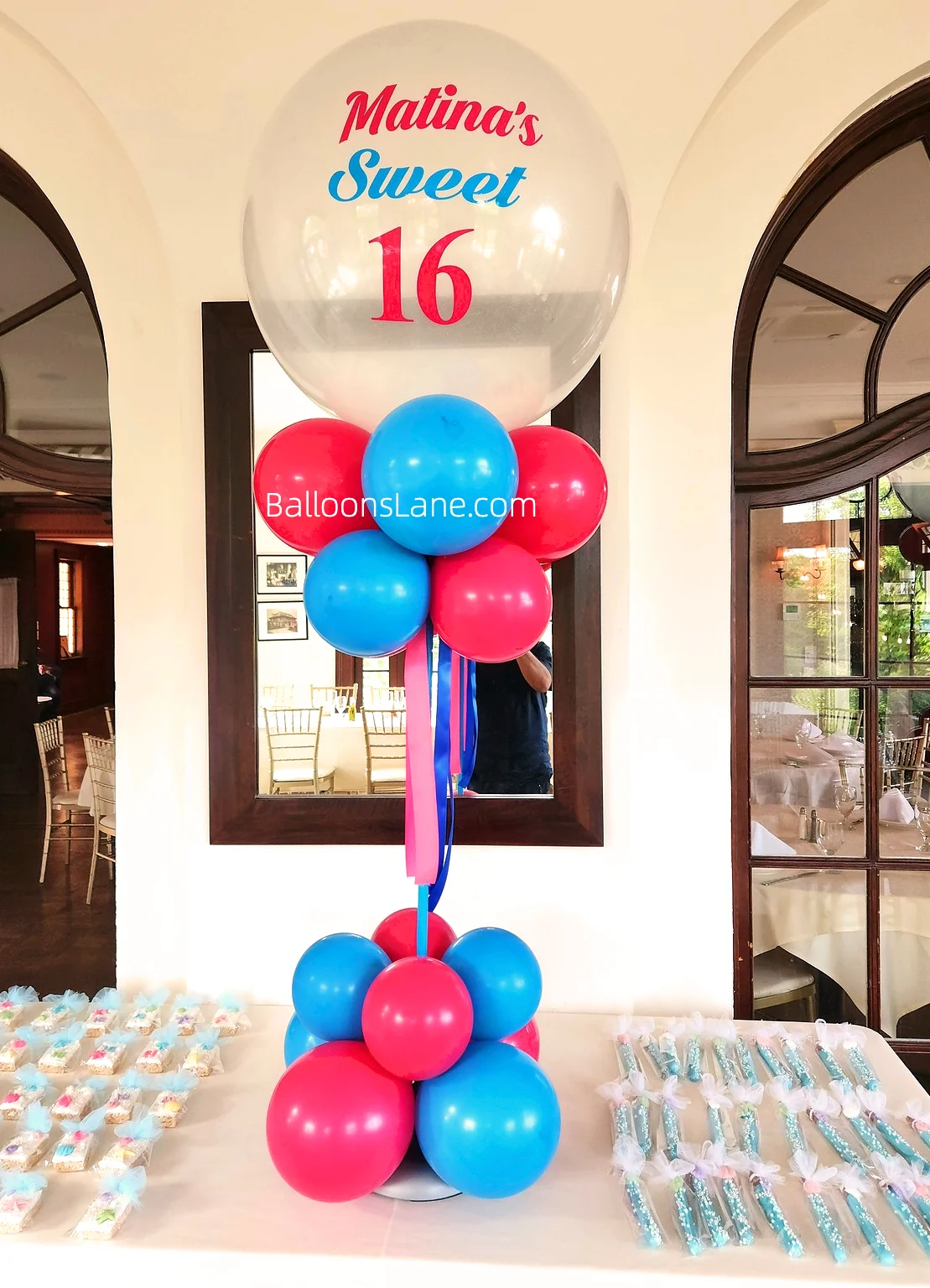 A bouquet arrangement featuring ash pink and blue balloons with a customized clear balloon on top, perfect for a 16th birthday celebration in Staten Island.