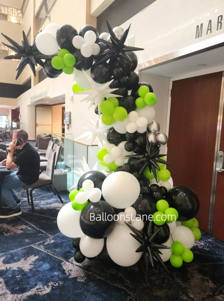 Black, Sea Green, and White Foil Balloon Half Arch with Silver Latex Balloons in Manhattan to Celebrate Birthday Corporate Event