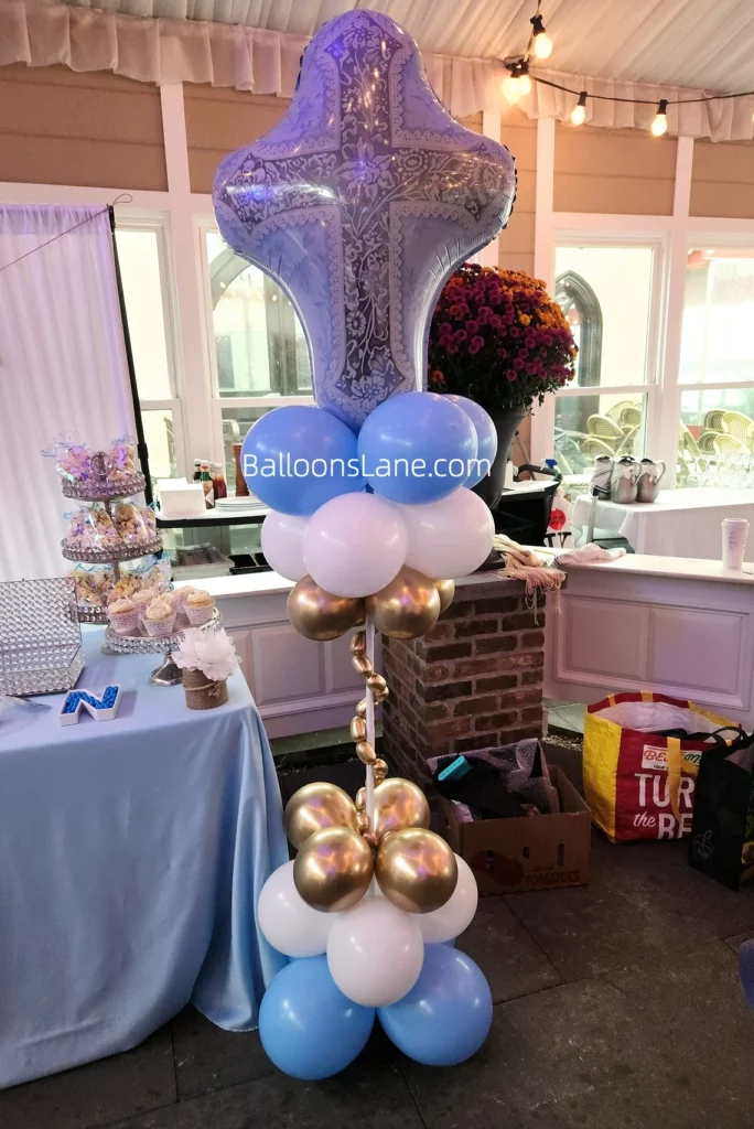 Balloons Lane balloon delivery in Brooklyn featuring white, blue, Caribbean blue, and navy balloons for a Communion or Christening event, with a large cross Mylar balloon floor column.