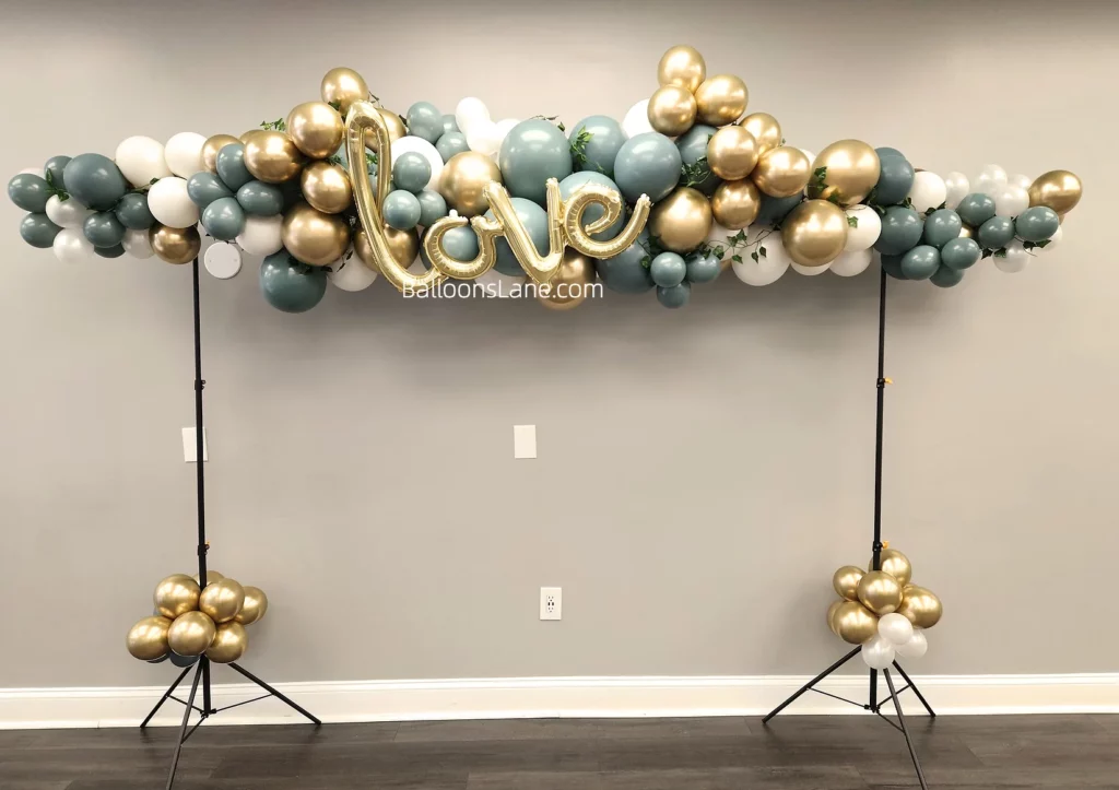 Gold LOVE letter balloons arranged in backdrop with white and gold latex balloons, perfect for engagements, anniversaries, or Valentine's Day celebrations in NYC