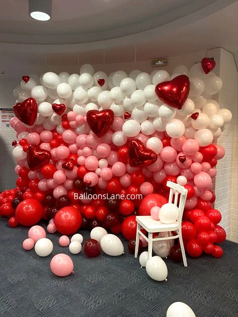 Valentine's Day Celebration in NJ with Red, White, and Pink Balloon Backdrop and Red Heart-Shaped Balloon