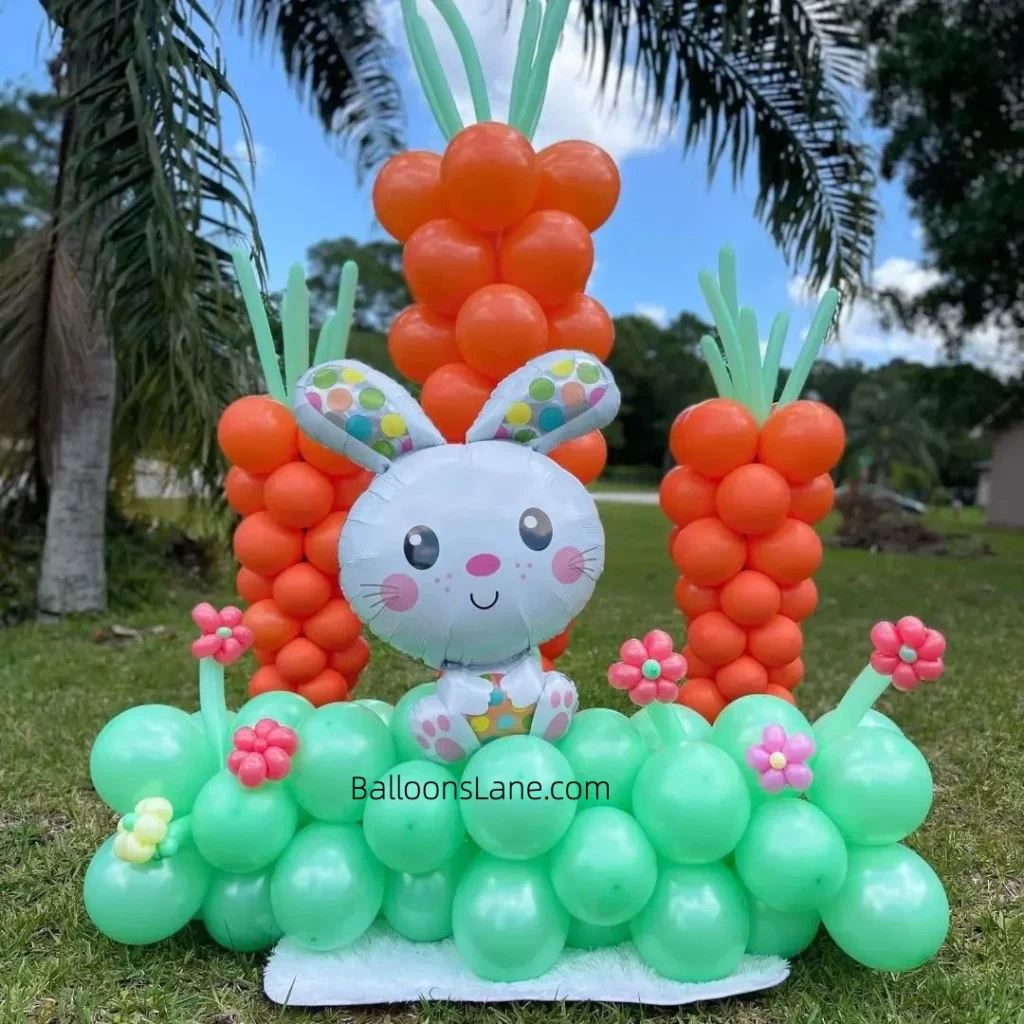 Beautiful Easter theme decor with green and pink flower balloons, white bunny green balloons, garland orange carrot , pink and purple balloon flowers and theme decor, in NJ