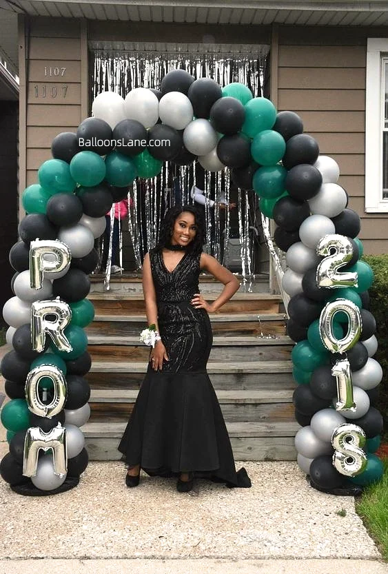 Silver "PROM" letter balloons and matching number balloons, elegantly mounted on an arch featuring green, black, and silver latex balloons.