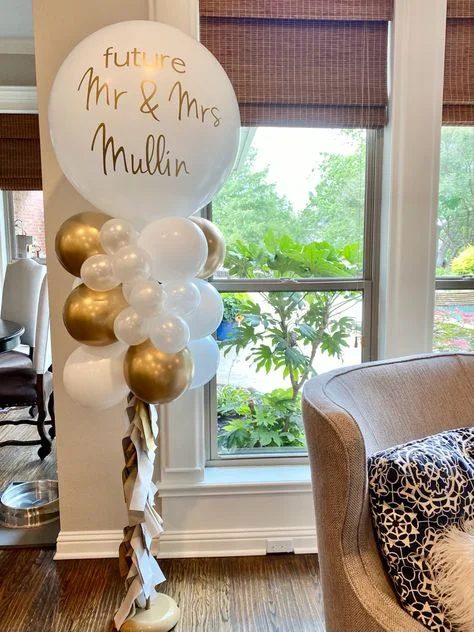 A customized 'Future Mr & Mrs' balloon atop a white and gold balloon stand, perfect for celebrating an engagement in Manhattan