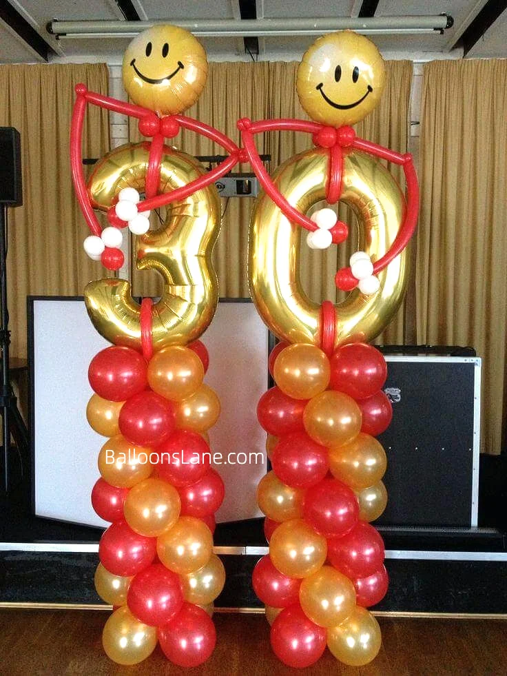 Gold 30th birthday number balloons accompanied by orange and red balloons, emoji balloon, and twisted balloon in NJ.