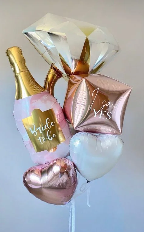 A customized bride-to-be ring bottle balloon accompanied by pink and white heart-shaped balloons, perfect for engagement celebrations in Brooklyn