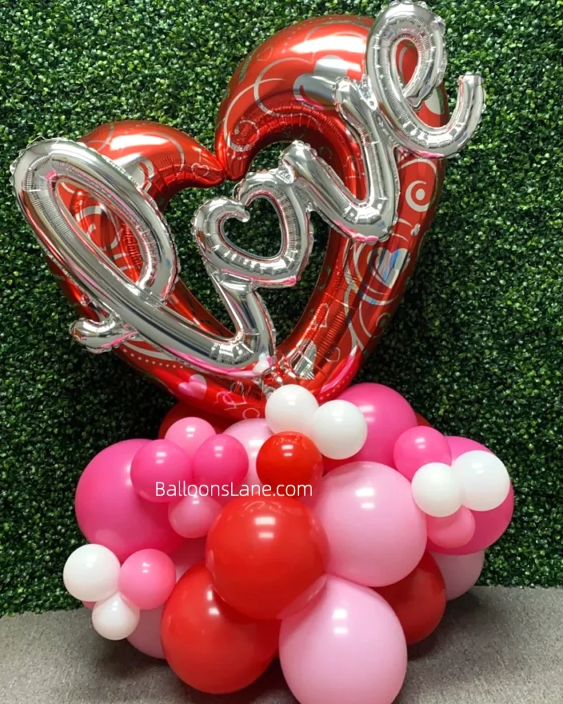 Silver "letter" balloons and red heart balloons on display.