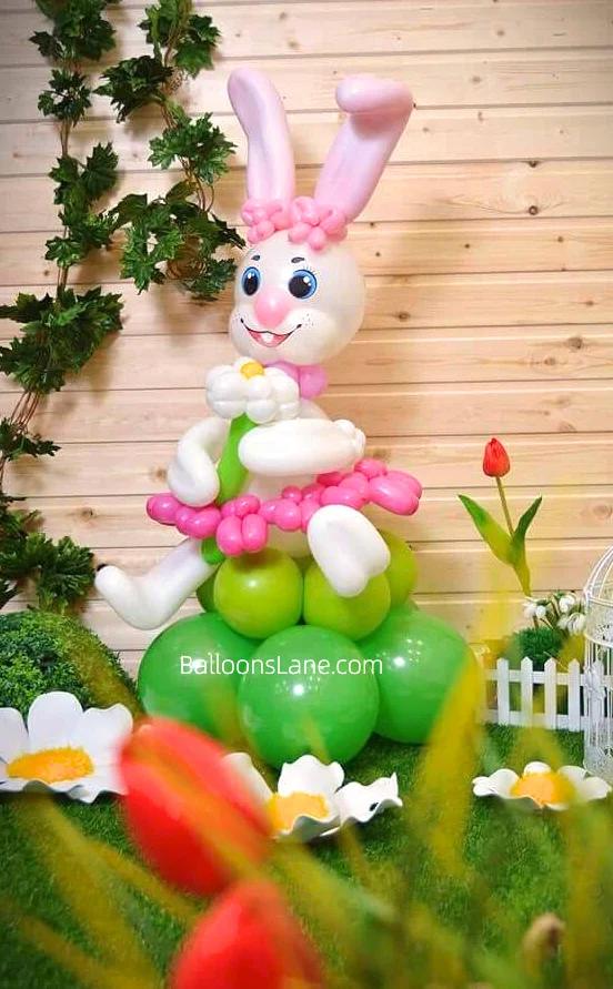 Bunny balloons made from Mylar balloons surrounded by pink, white, and green balloons, arranged in a bunch to celebrate Easter in NYC.