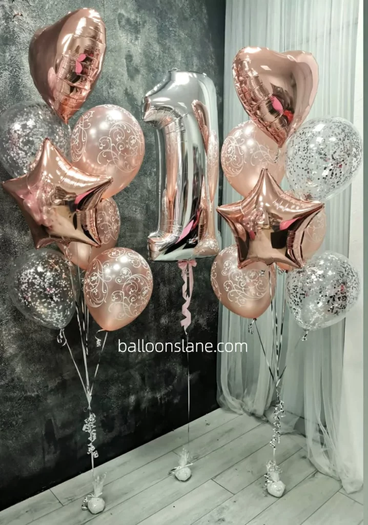 Beautiful rose gold and textured balloons in silver and pink, along with number 1 balloons arranged in a bouquet to celebrate a first birthday in Manhattan