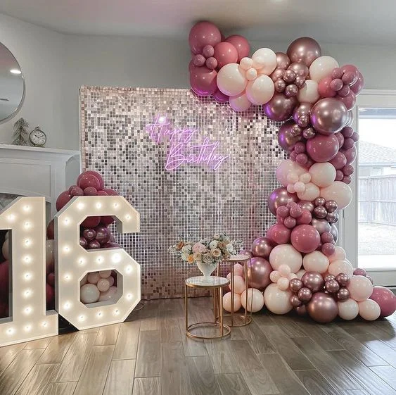 Sweet 16 birthday celebration featuring a half arch of rose and pink Chrome Rose Gold balloons to make your loved one's birthday special in NYC.