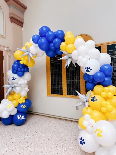 Garland made of blue, yellow, and white latex balloons with a customized Pitt balloon and Mylar star.