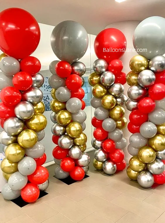 Striking big red latex balloon columns adorned with red, white, and silver and gold balloons, designed to celebrate Valentine's Day and placed at the entrance of your showroom.
