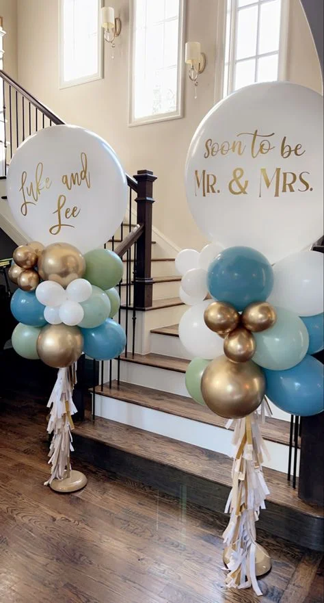 Soon to be Mr. & Mrs." balloon stand adorned with blue, gold, and sea green balloons to celebrate engagement in Brooklyn