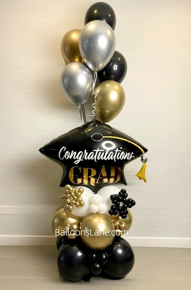Customized Graduation Cape Foil Balloon with Silver, Gold, and Black Chrome Balloons, White Balloons, and Small Gold and Black Balloons in NYC