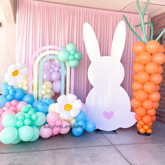 Easter balloon decor featured personalized bunny balloons, latex balloons, Mylar balloons in blue, orange flowers, pink, and blue balloons arranged as backdrops, garlands, and columns in Brooklyn.