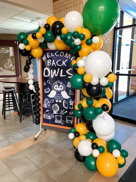 Balloons Garland with Multiple Sizes and Multicolor Balloons: Green, Orange, White, and Black, to Celebrate Welcome Back Party at Brooklyn Schools
