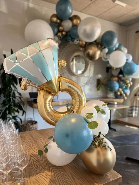 Gold, white, and blue foil ring balloon surrounded by a bouquet and garland of balloons in matching colors in NJ