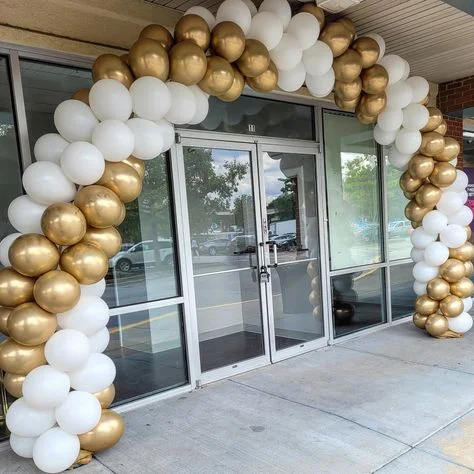 Arch made of white and gold latex balloons.