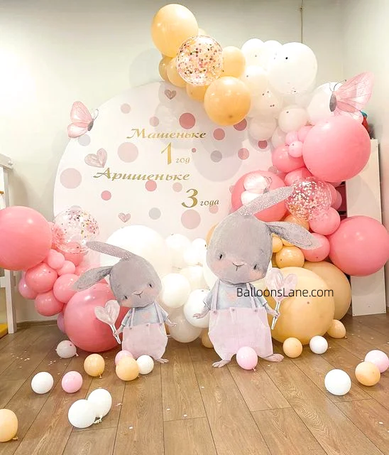 The pink and white balloon backdrop featured peach and confetti balloons in different sizes, featuring a birthday and Easter theme.