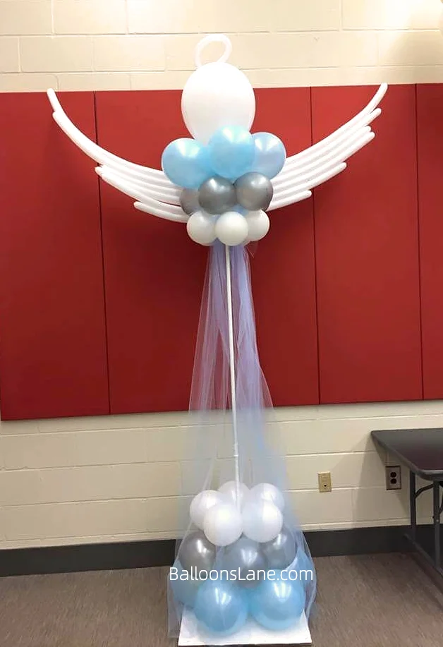 Baptism bird sign balloon columns with white, silver and pearl blue balloons arranged as a backdrop in Brooklyn.