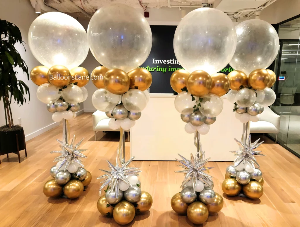 Bridal shower balloons column adorned with large clear balloons, gold latex balloons, silver star balloon, and silver and white balloons in Manhattan
