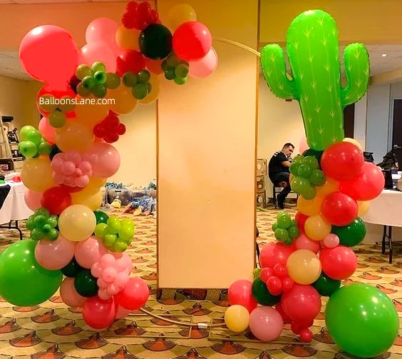 Balloon arch with pink, green, orange, and yellow balloons for a Cinco de Mayo celebration in Brooklyn
