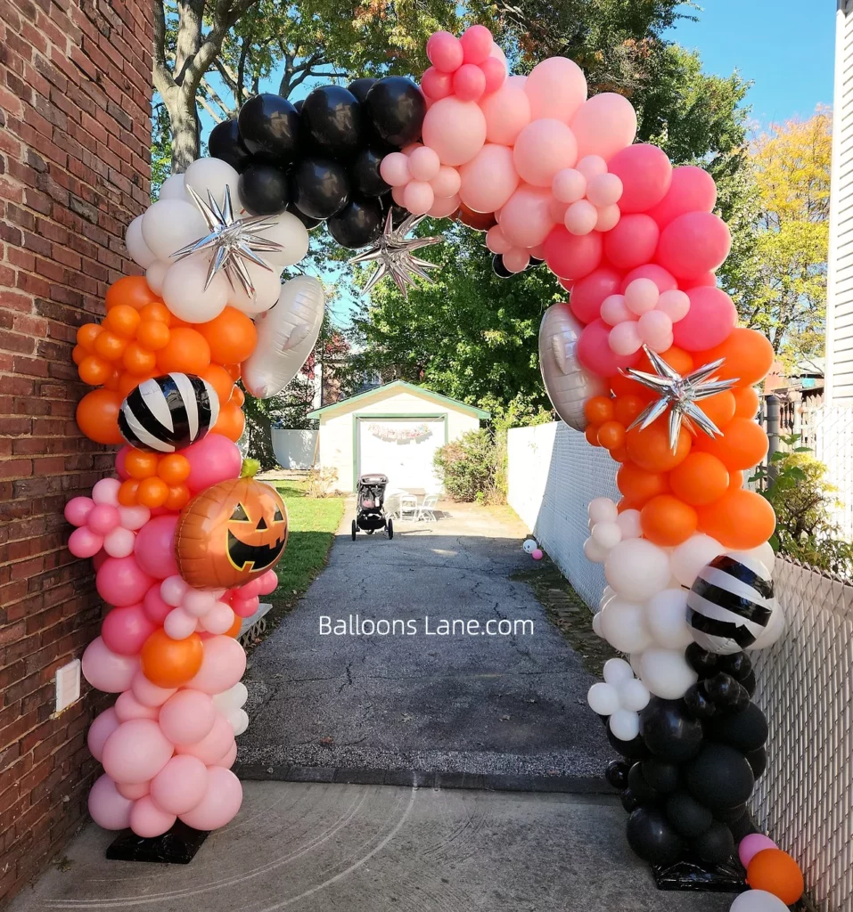 Halloween balloon arch in Brooklyn featuring pink, red, black, and white balloons